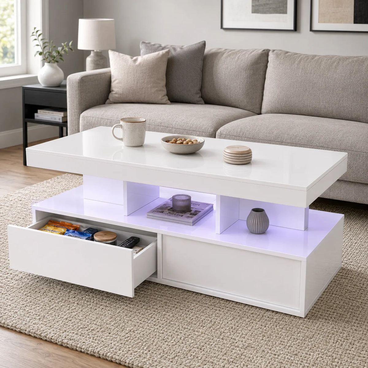 White coffee table with open shelf, two drawers, and purple LED underglow