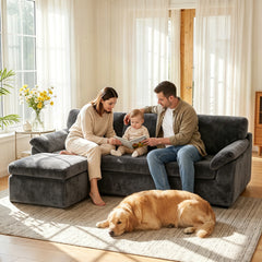 Dark gray convertible sofa bed with chaise sections, with family relaxing nearby