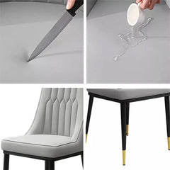 Light gray dining chair details: tufted back, padded seat, black legs with gold tips