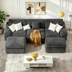 Dark gray convertible sofa bed with tufted back, chaise extensions, and cushions