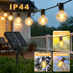 Outdoor globe LED solar string lights with connected solar panel and lit bulbs.