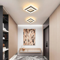 Two square LED ceiling lights, white frames with black centers, warm illumination