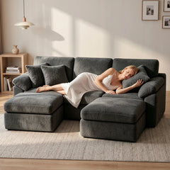Dark gray convertible sofa bed with chaise extensions, shown as a sleeper layout