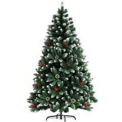 Artificial green Christmas tree with pine cones and red berries, full standing view with base