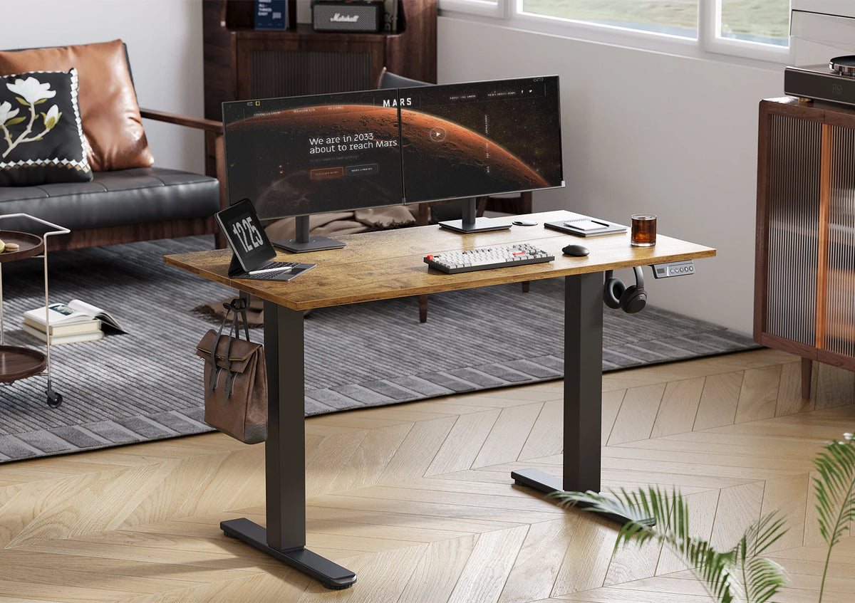 Brown electric standing desk with flat top, black frame, and hook side