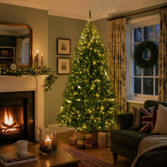 Green artificial Christmas tree with warm white lights and metal stand