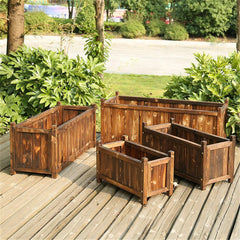 Rectangular wooden raised planter box with internal dividers and open top for plants