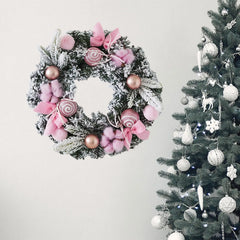 Winter wreath with pink bows, fuzzy pom poms, and rose-gold ball accents.