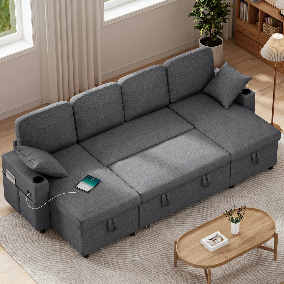 Dark grey fabric sofa bed with chaise, pull-out double sleeper and storage compartments