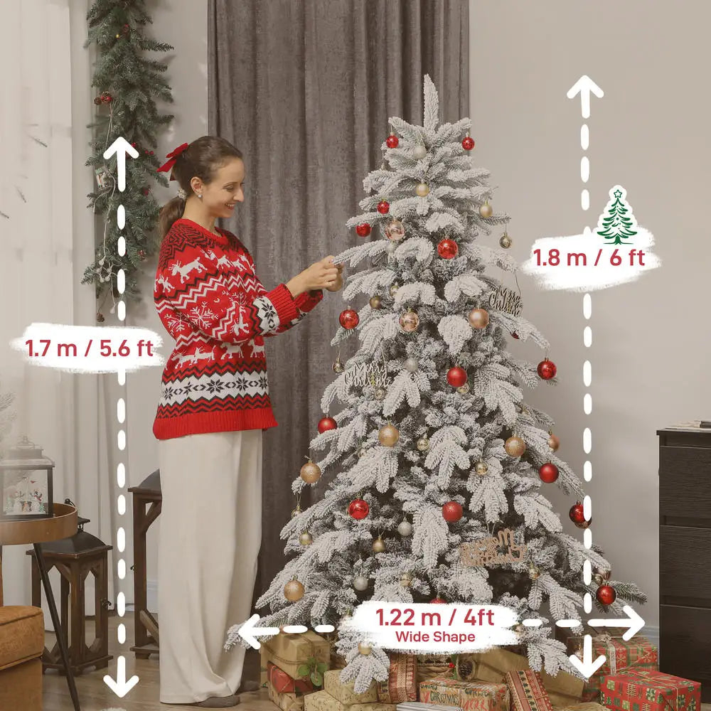 Flocked artificial Christmas tree with red and gold ornaments, full tall silhouette