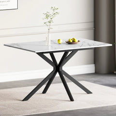 Rectangular extendable dining table with white marble-look top and black X legs.
