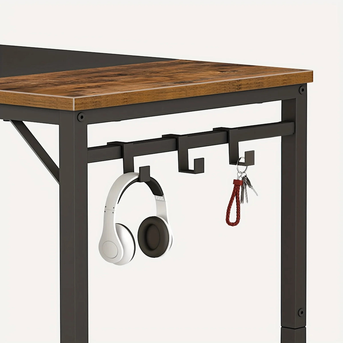 Computer desk corner close-up with hanging hook pegs under the brown top surface