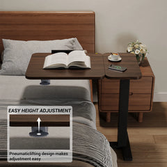 Overbed desk with tilting tabletop and black base near bed