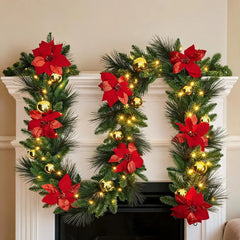 Rustic pine vine Christmas wreath with red poinsettias and glowing warm lights