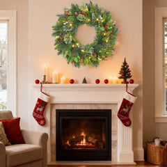 Christmas vine wreath with pine greenery, red baubles, and warm golden lights