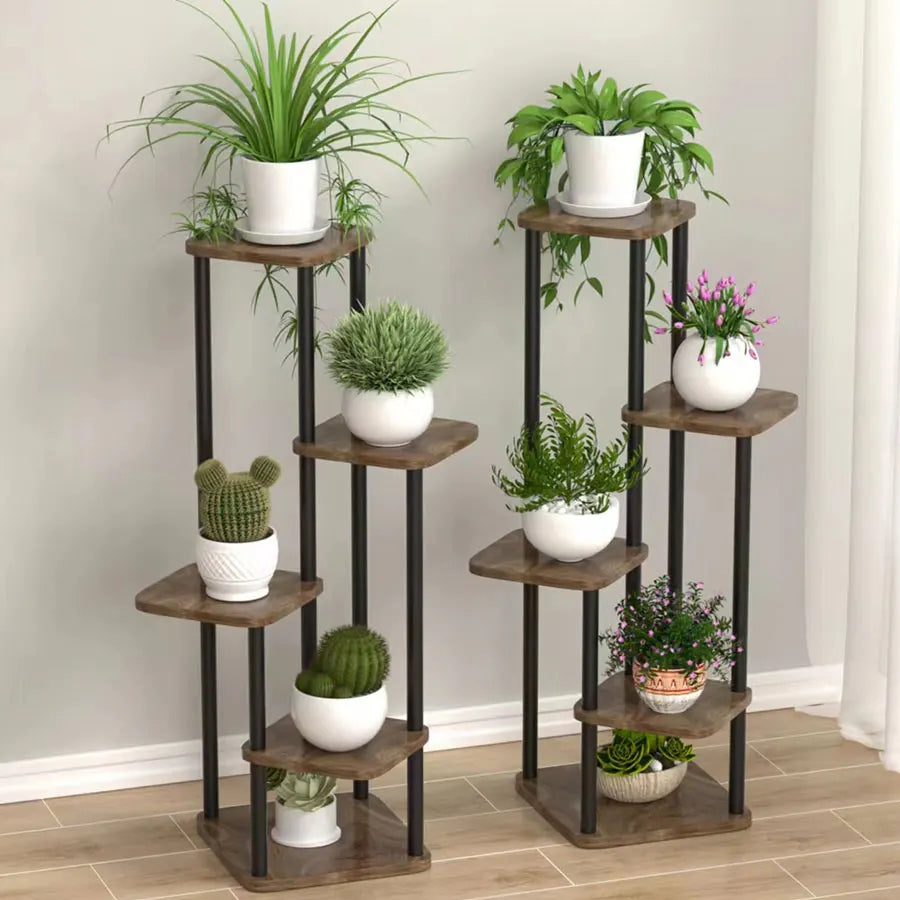 Multi-tier plant stand with brown shelves and black metal frame, potted plants