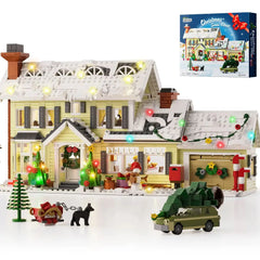 White Christmas house building blocks set with lit lights, tree, and green truck accessory