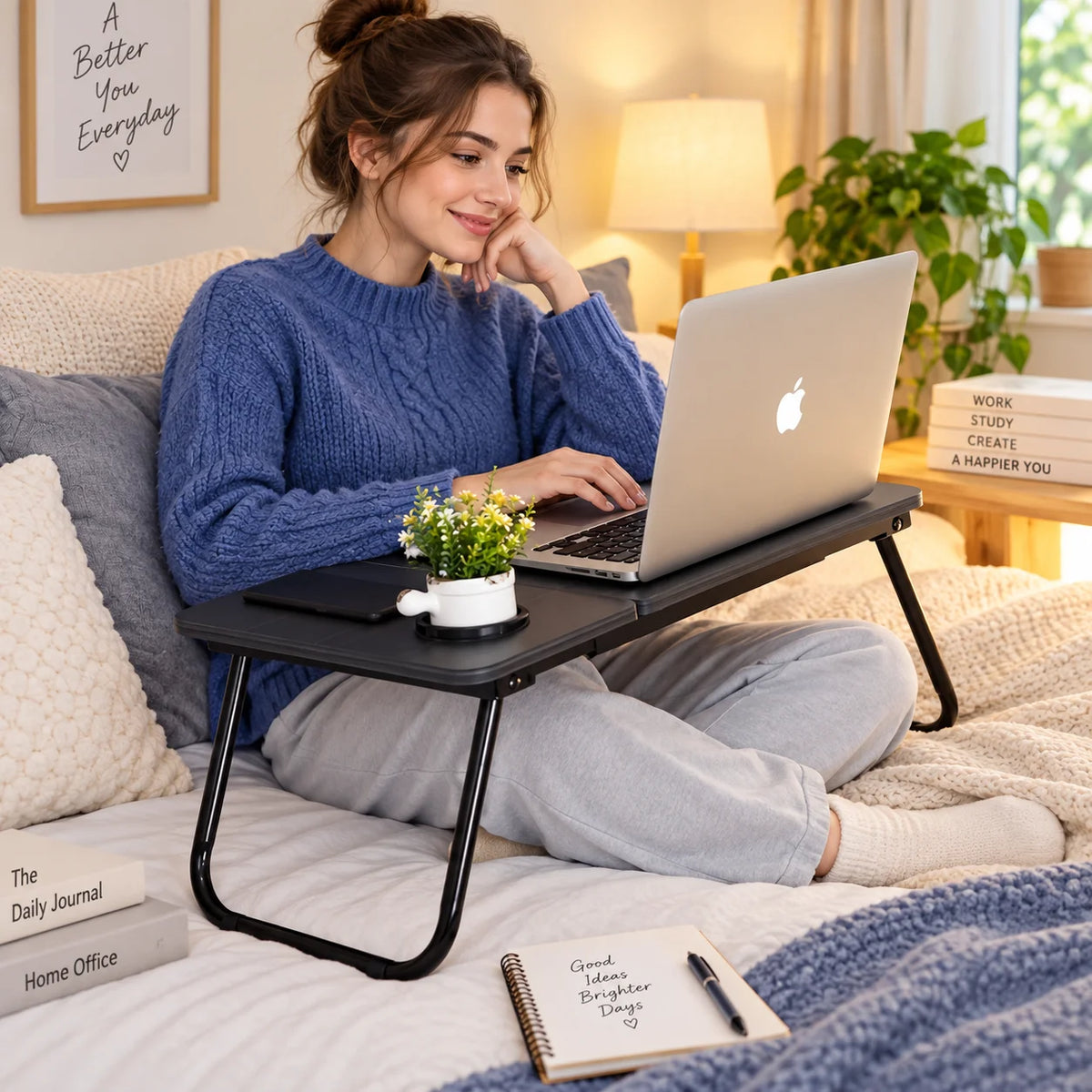 Folding laptop table tray with black top, slim legs, and cup holder