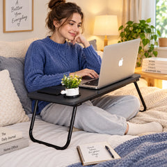 Folding laptop table tray with black top, slim legs, and cup holder