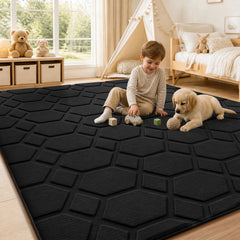 Black hexagon geometric area rug with textured low-pile surface and non-slip backing