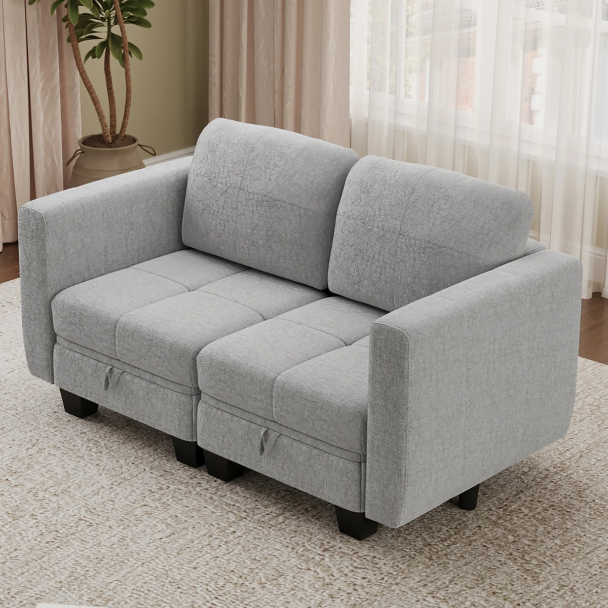 Grey fabric modular sofa section with three back cushions and boxy seat blocks