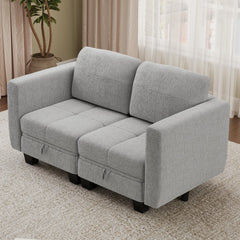 Grey fabric modular sofa section with three back cushions and boxy seat blocks