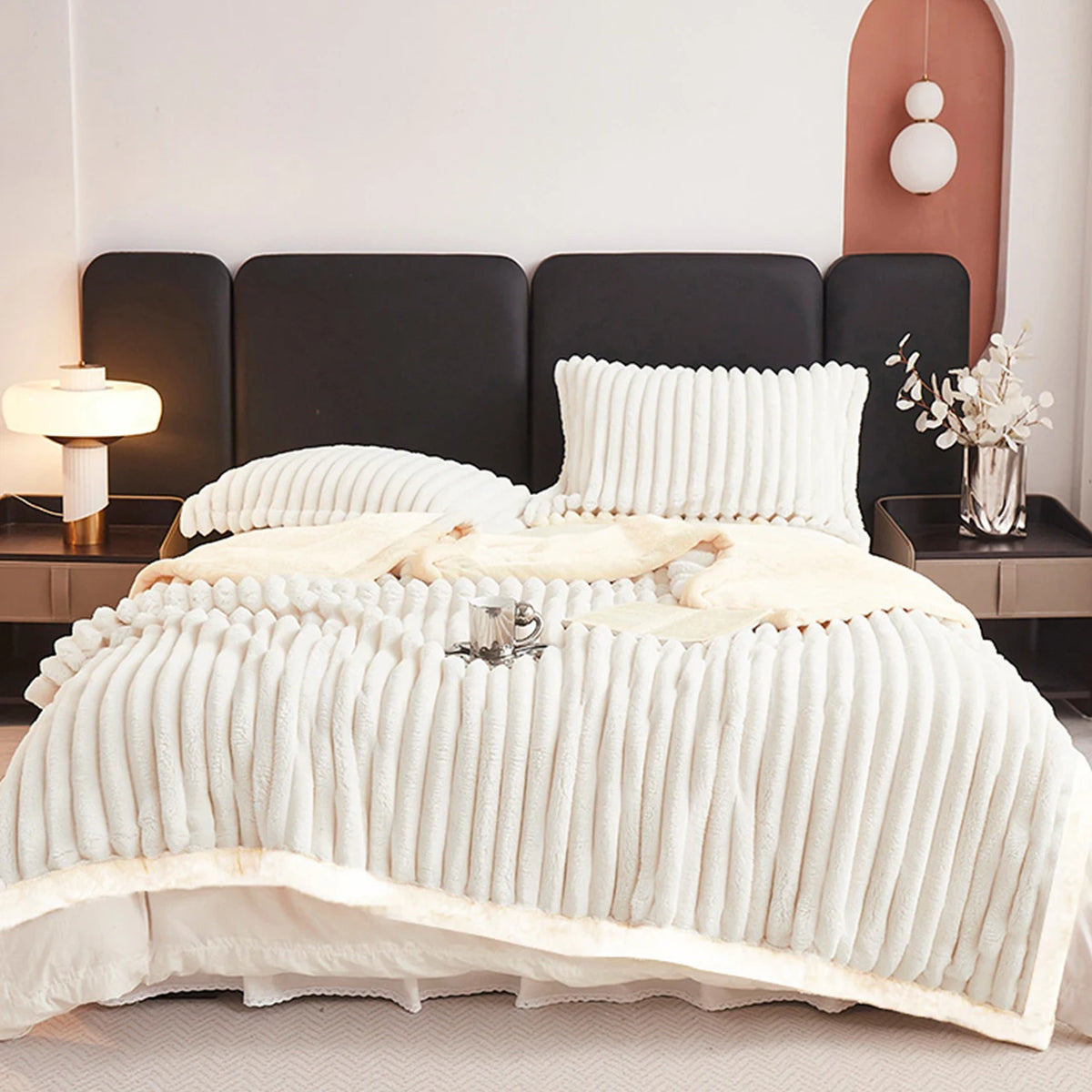 Cream weighted fleece blanket with thick ribbed texture, cozy sherpa-style trim