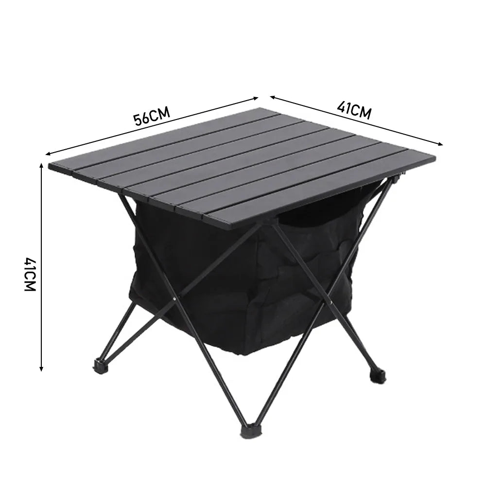 Breeins folding camping table with dark gray top, black legs, attached storage bag