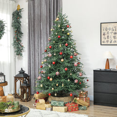 Artificial green spruce Christmas tree decorated with red baubles and warm white lights