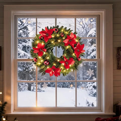 Christmas wreath with red poinsettia-style accents and warm white string lights