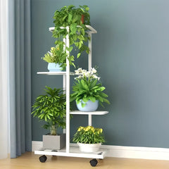 White 6-tier plant shelf rack with slatted shelves and wheels, potted plants on display