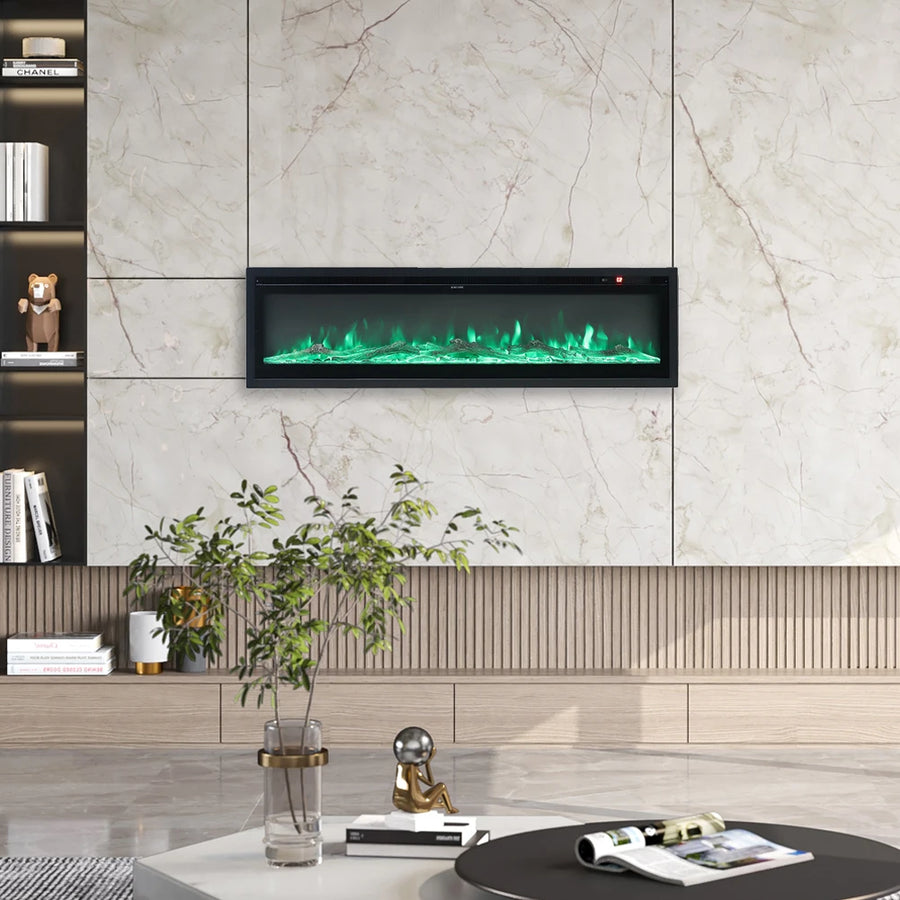 Recessed electric fireplace with green LED flame glow in a white marble wall surround