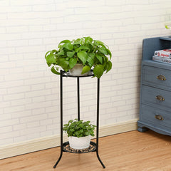 Black metal 2-tier plant pot rack with round shelves, green plants in white pots on top
