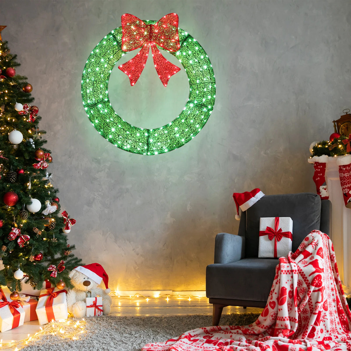 Green LED Christmas wreath with red bow, glowing outdoors on a wall
