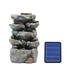 Solar outdoor rockery fountain with dark gray stone tier and solar panel beside it