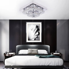 Clear crystal and chrome ceiling chandelier light centered on room ceiling