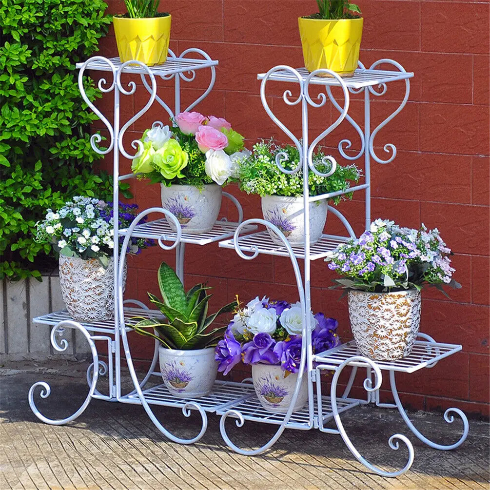 Four-tier white metal plant stand with heart scrollwork shelves