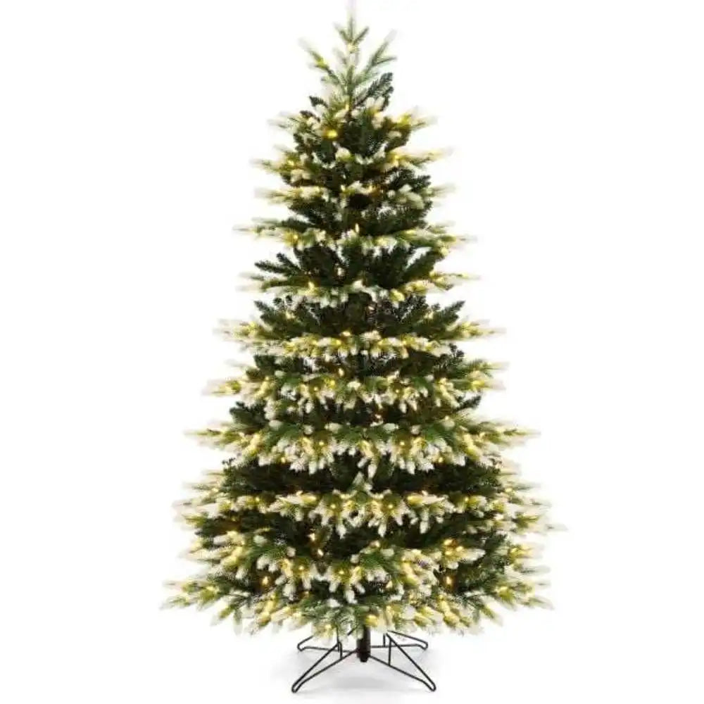 Artificial Christmas tree with full green branches and metal tripod stand