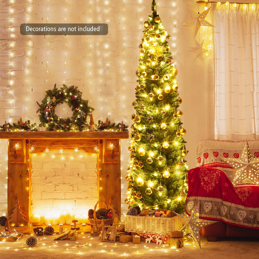 Tall slim pencil artificial tree with golden warm lights and decorative ornaments