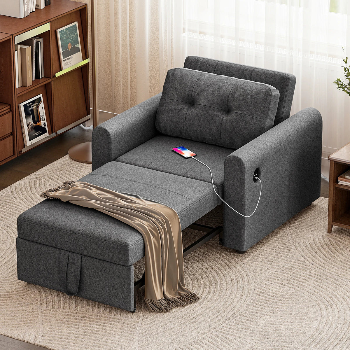 Dark grey sofa bed chair with tufted back, arm cutout, and pull-out sleeping base
