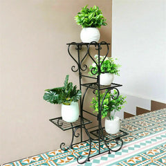 Four-tier black metal plant stand with curving scroll shelves
