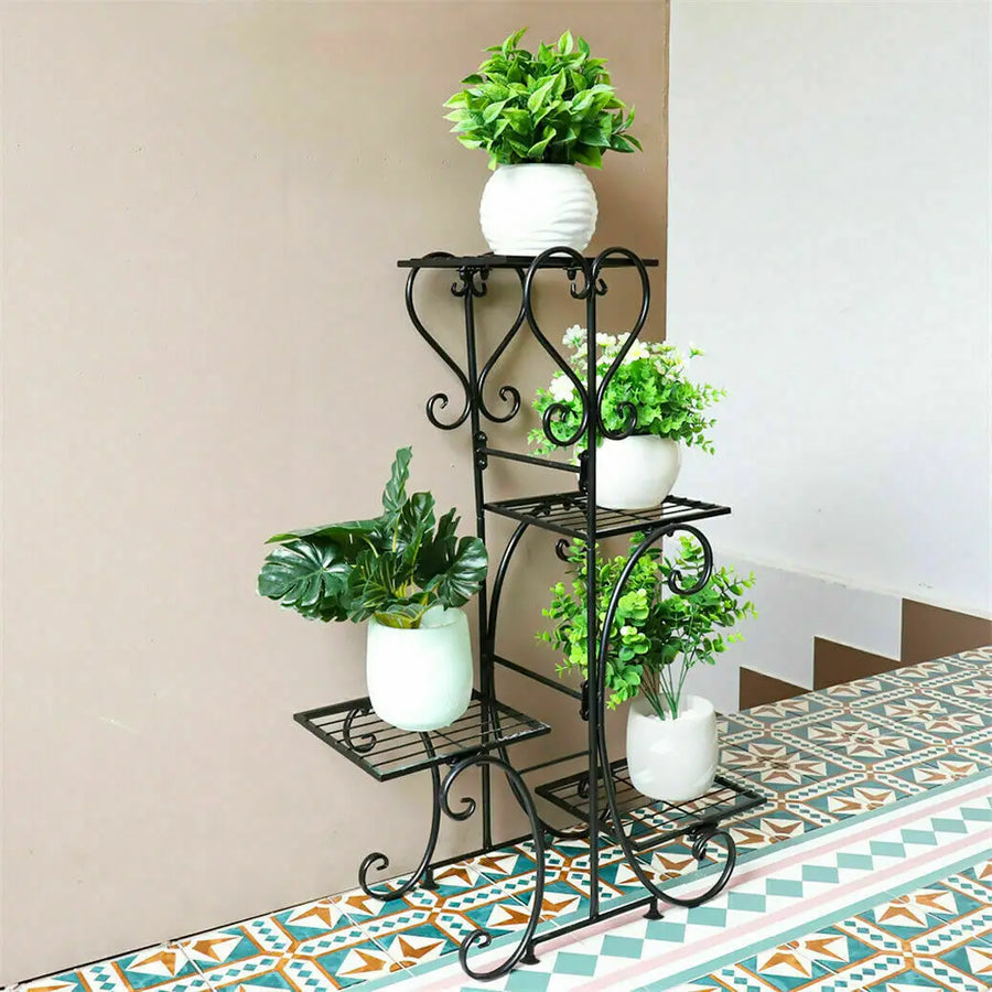 Four-tier black metal plant stand with curving scroll shelves