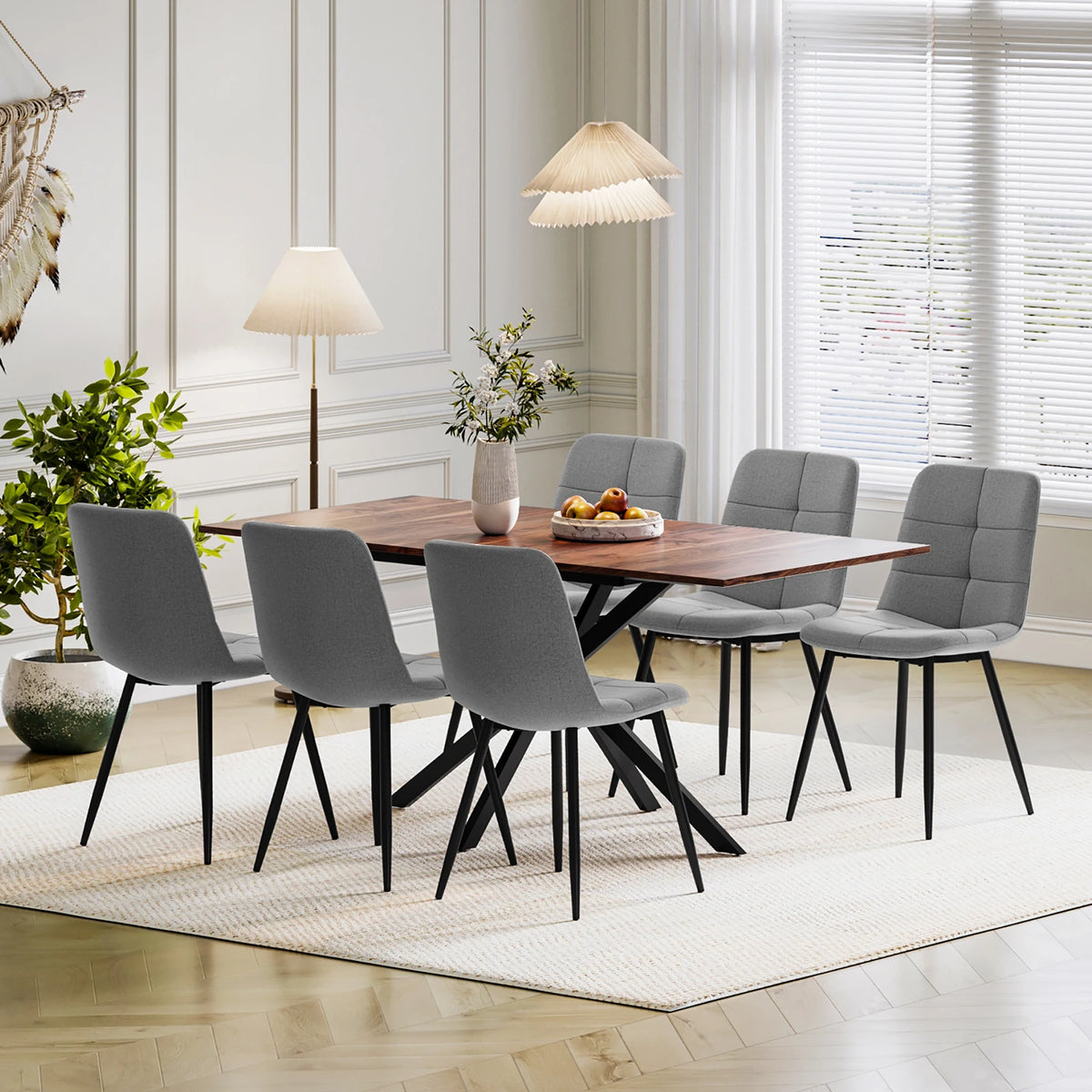 Rectangular dining table with 4 upholstered chairs, gray seats and backs, black legs