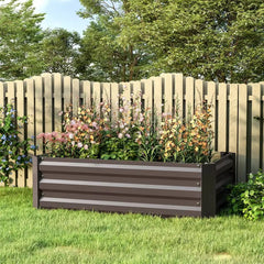 Outdoor raised bed planter with dark gray slatted sides, filled with flowers in garden.