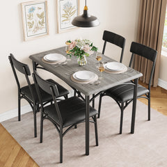 Rectangular dining table with dark tabletop and four black upholstered dining chairs