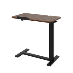 Adjustable overbed table with tilting top, dark wood surface, and black base