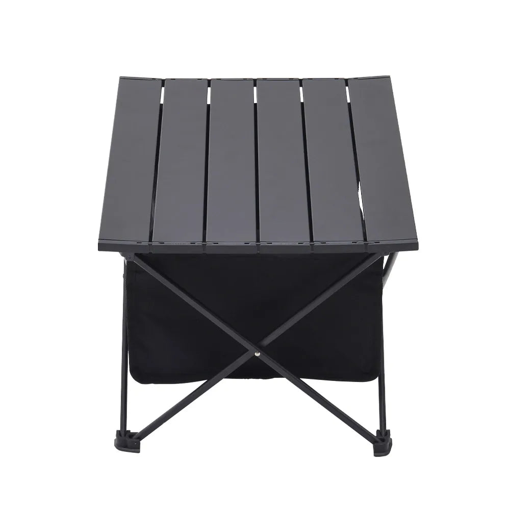 Black folding camping table with hinged slatted top and storage bin
