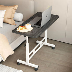 Mobile standing desk with black tabletop, white frame, and caster wheels