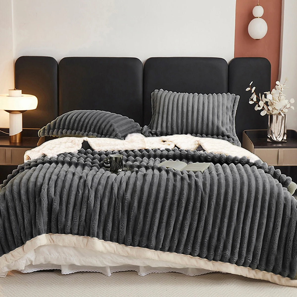 Dark gray weighted fleece blanket with chunky ribbed weave and soft off-white edge