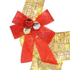 Close-up of golden reindeer ornament with large red bow and glossy bell ornaments